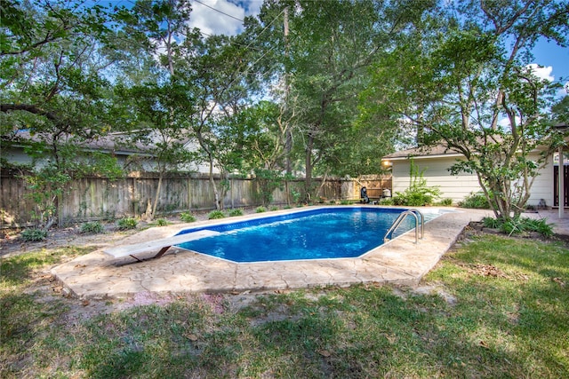 view of swimming pool featuring a diving board and a patio