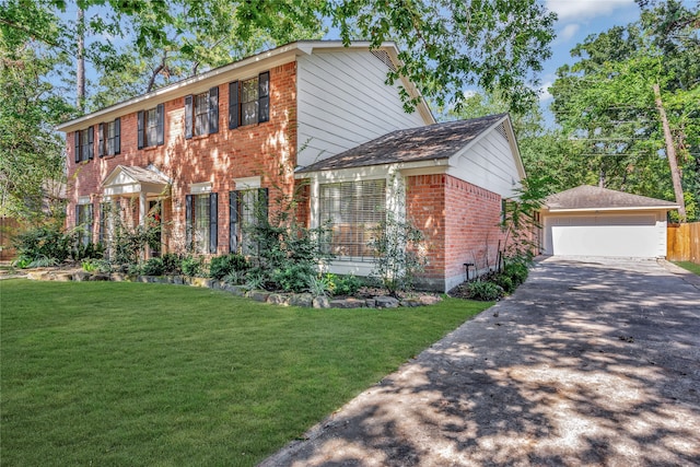 colonial house featuring a front lawn and a garage