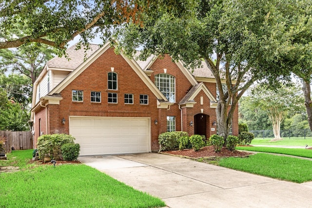 view of front of property with a front yard and a garage