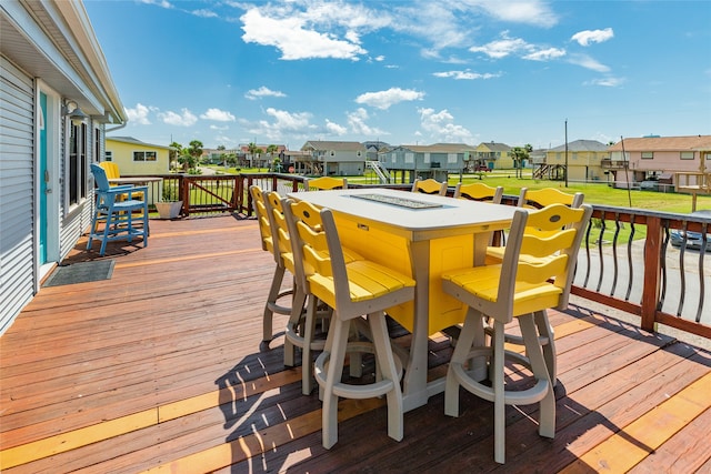 deck featuring a fire pit and a lawn