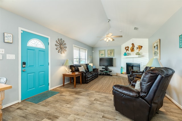 foyer featuring vaulted ceiling, ceiling fan, and light hardwood / wood-style floors