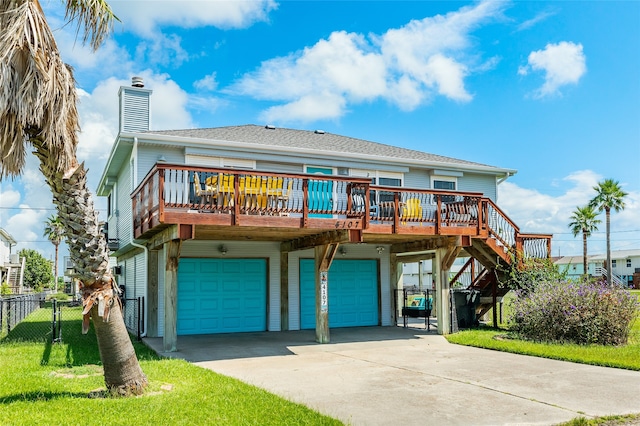 view of front of house with a front lawn, a deck, and a garage