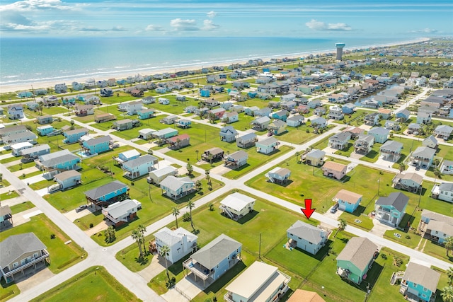 drone / aerial view with a water view and a beach view