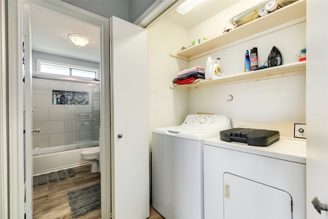 laundry area with washer and dryer and hardwood / wood-style flooring