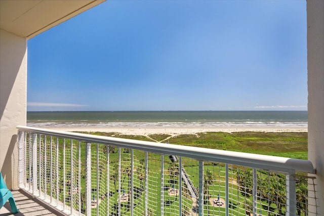 balcony featuring a water view and a beach view