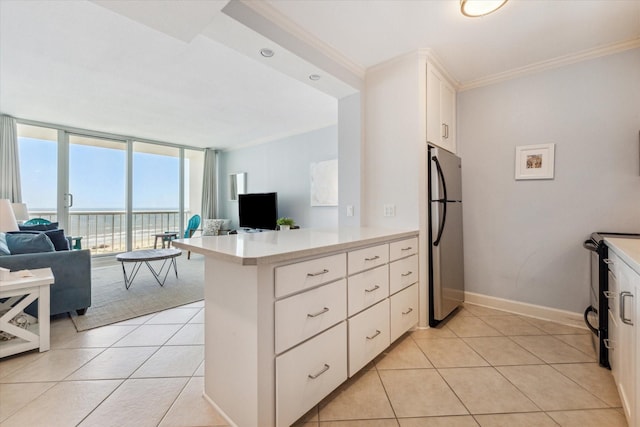 kitchen featuring kitchen peninsula, stainless steel fridge, floor to ceiling windows, white cabinets, and black electric range oven