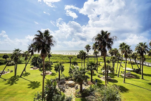 view of property's community with a yard and a water view