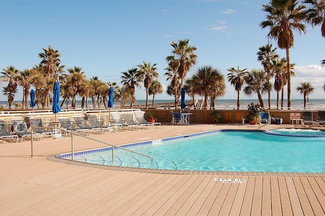 view of swimming pool featuring a patio area and a water view