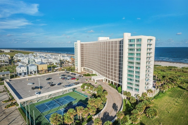 drone / aerial view featuring a water view and a view of the beach