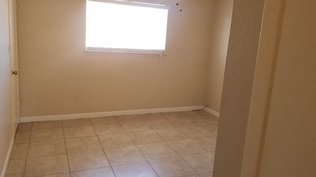 empty room with light tile patterned floors