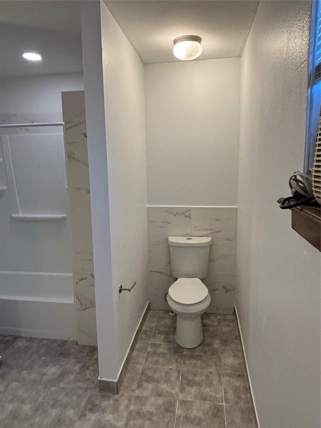 bathroom with wainscoting and toilet