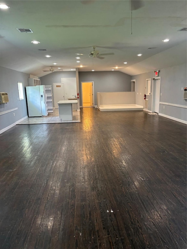 interior space featuring a ceiling fan, baseboards, vaulted ceiling, and hardwood / wood-style floors