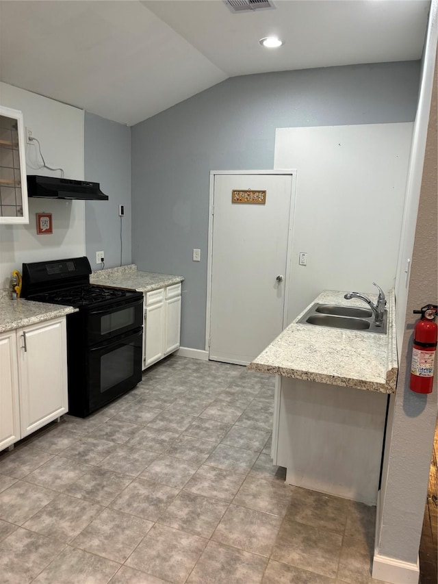 kitchen with lofted ceiling, under cabinet range hood, a sink, visible vents, and double oven range