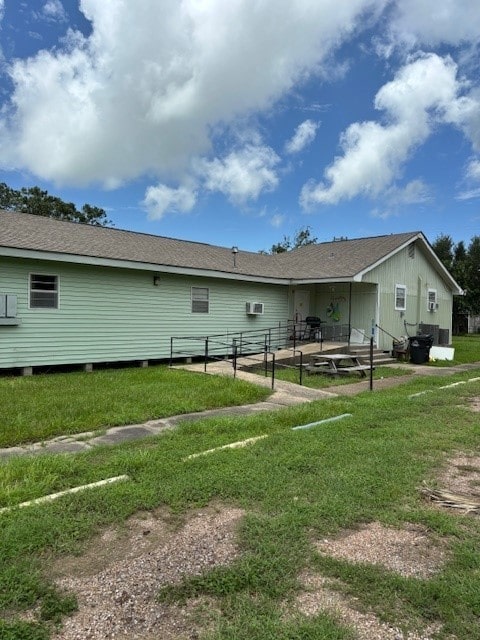 back of house with a lawn