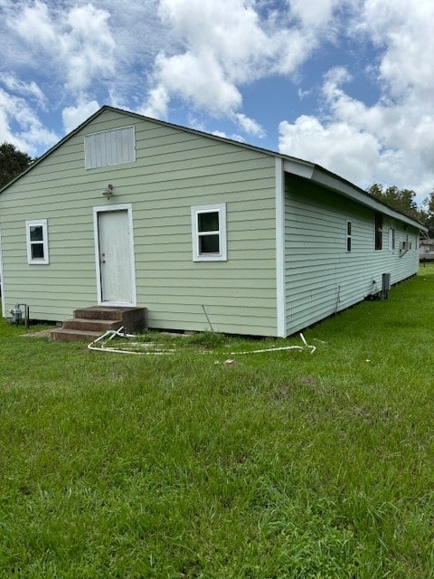 back of property featuring a yard