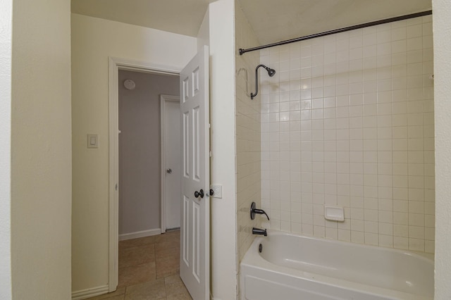 bathroom featuring tiled shower / bath combo and tile patterned floors