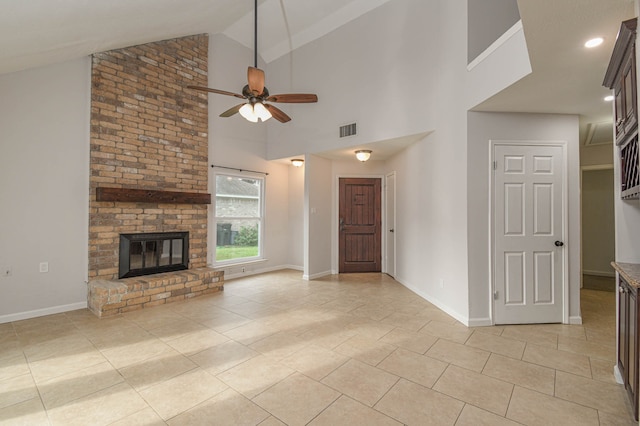 unfurnished living room featuring light tile patterned floors, high vaulted ceiling, ceiling fan, and a brick fireplace