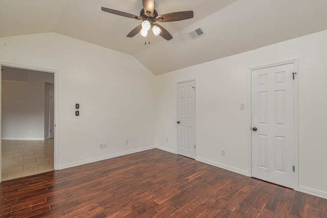 unfurnished room featuring ceiling fan, lofted ceiling, and dark wood-type flooring