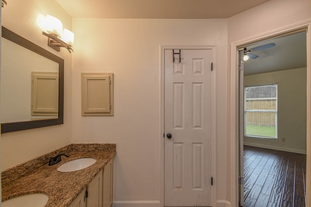 bathroom featuring wood-type flooring, vanity, and ceiling fan