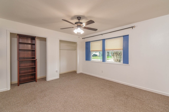 unfurnished bedroom featuring ceiling fan, a closet, and carpet