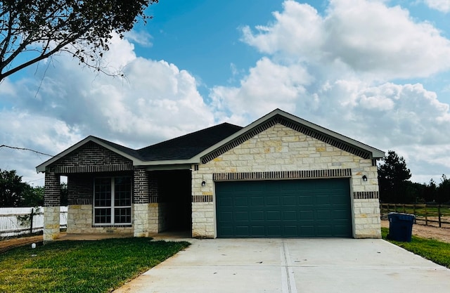 view of front of home featuring a garage and a front yard