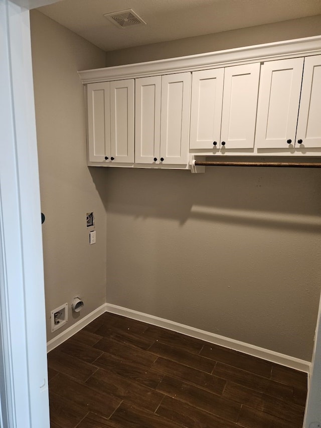 washroom with cabinets, dark hardwood / wood-style flooring, electric dryer hookup, and hookup for a washing machine