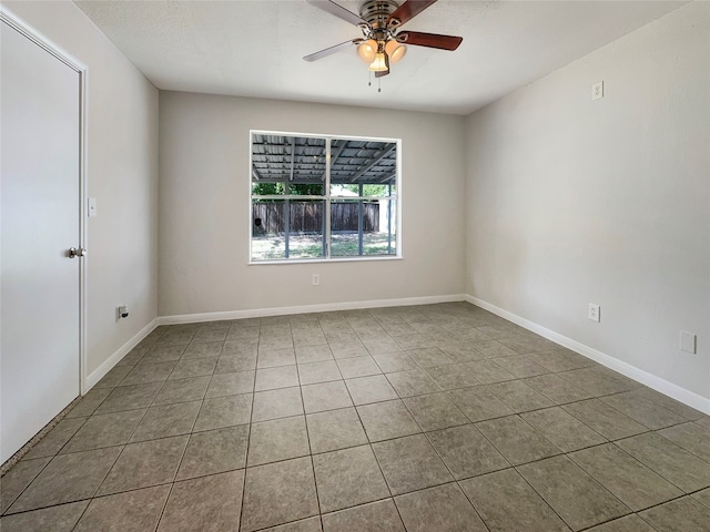 unfurnished room featuring ceiling fan and tile patterned floors