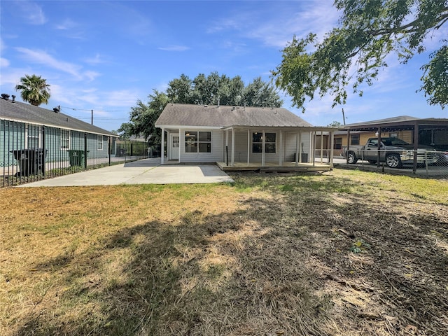 rear view of house with a lawn and a patio