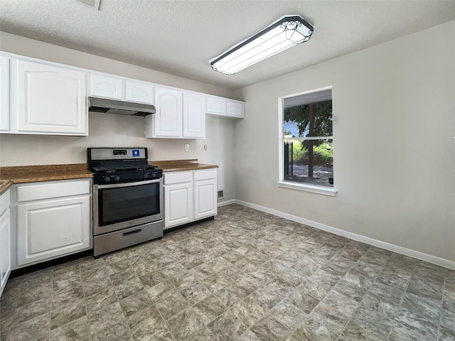 kitchen with white cabinetry, a textured ceiling, and stainless steel range oven