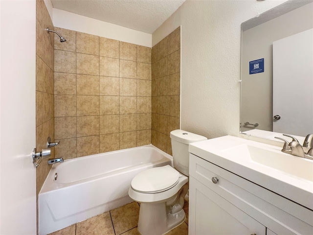 full bathroom featuring a textured ceiling, tiled shower / bath combo, vanity, and toilet