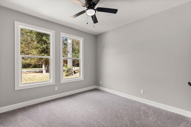 empty room with ceiling fan and carpet