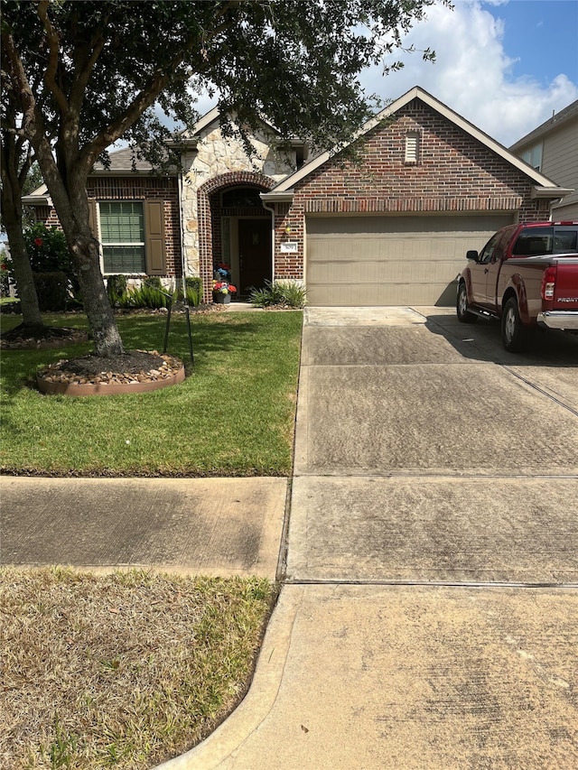 view of front of property featuring a garage and a front lawn