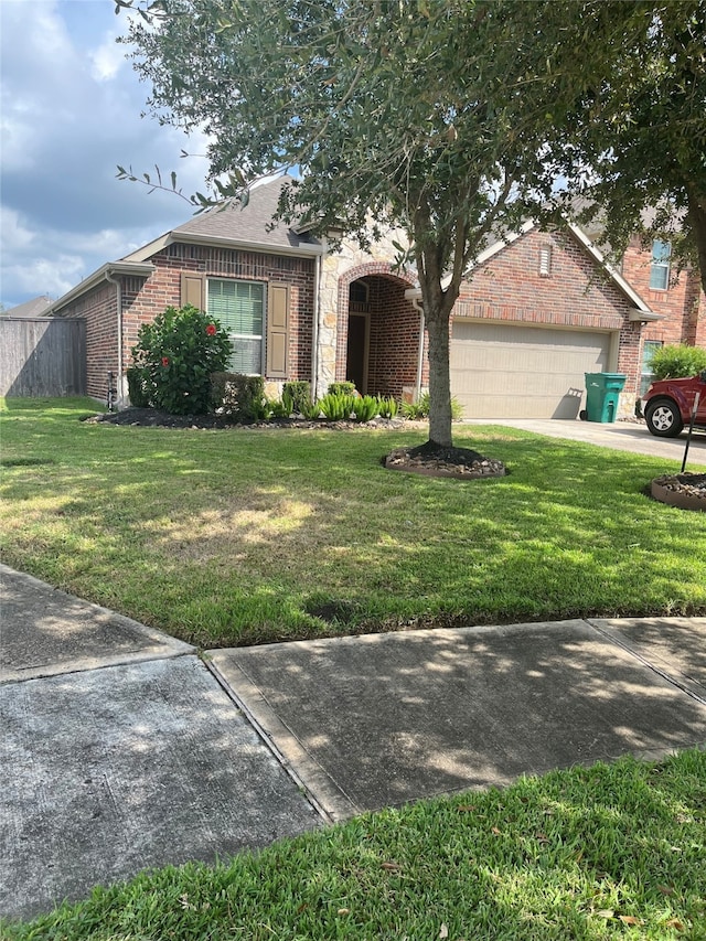 ranch-style home with a front yard and a garage