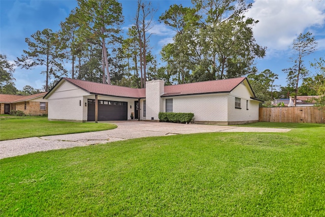 ranch-style home with a front lawn and a garage