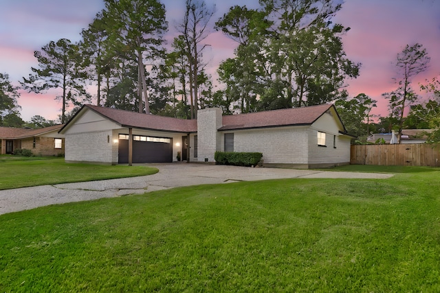 view of front of house featuring a lawn and a garage