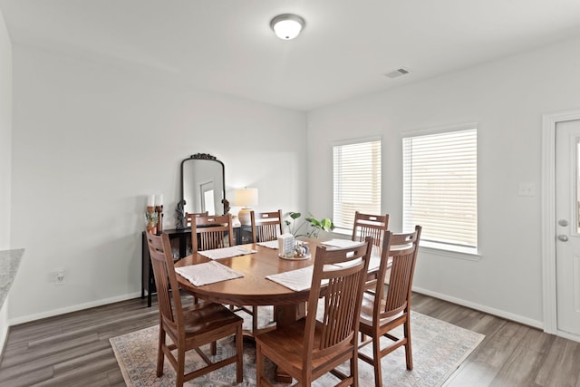 dining space featuring dark wood-type flooring