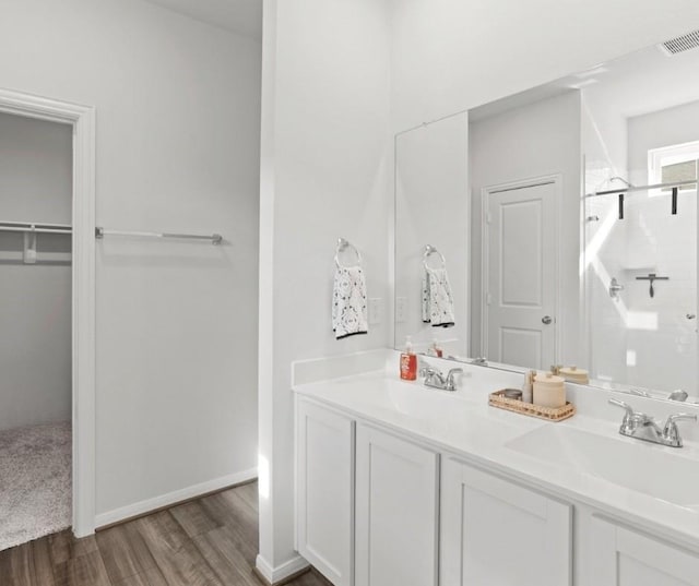 bathroom with a shower with door, wood-type flooring, and vanity