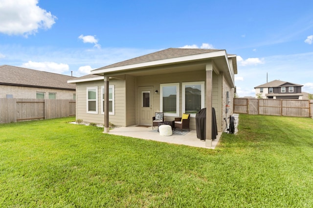 back of house with a lawn and a patio area