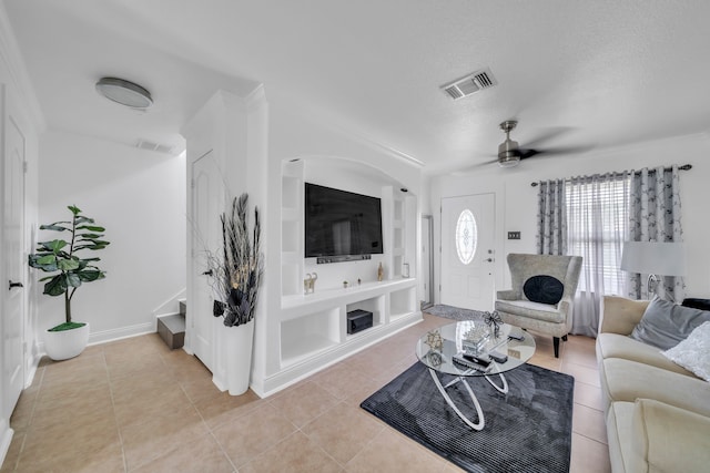 tiled living room featuring a textured ceiling and ceiling fan