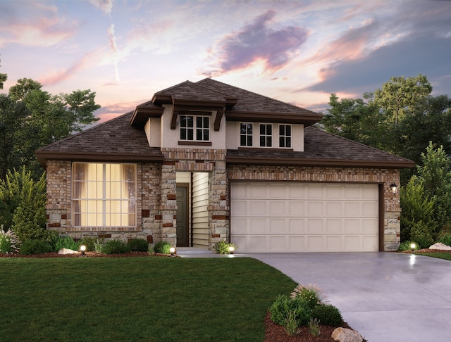 view of front of home with a yard and a garage