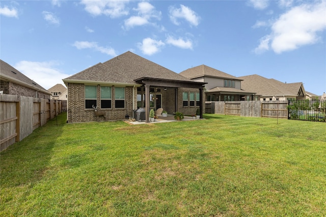 back of property featuring a yard and a patio