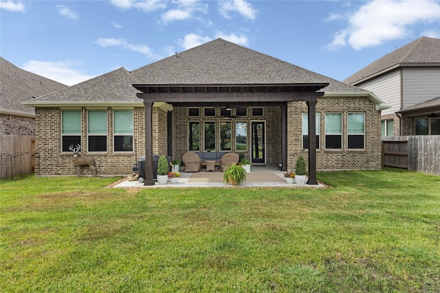 back of property featuring a yard, an outdoor living space, and a patio