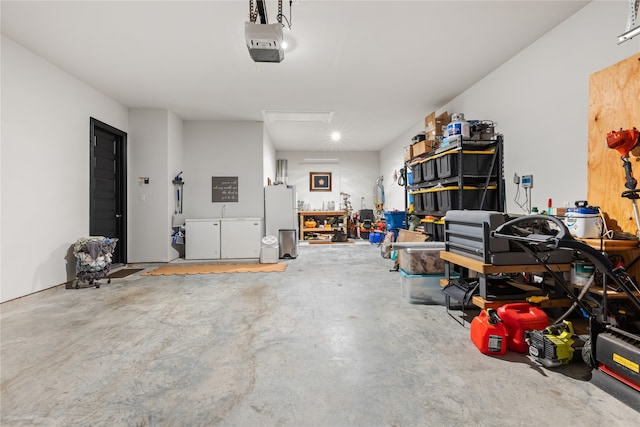 garage featuring a garage door opener, refrigerator, and a workshop area