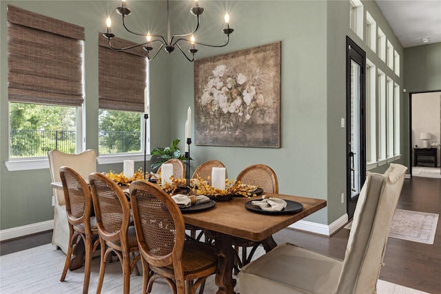 dining area featuring hardwood / wood-style floors and a notable chandelier