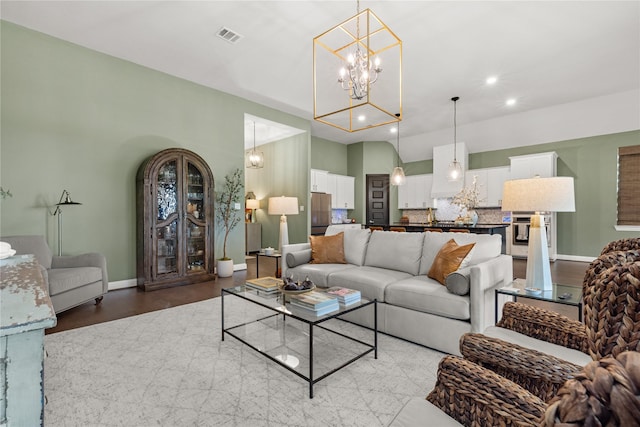 living room featuring light hardwood / wood-style flooring and a chandelier