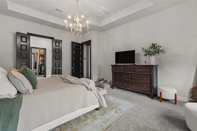 bedroom featuring a raised ceiling, light carpet, and an inviting chandelier