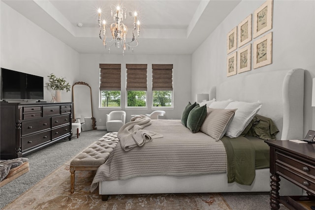 carpeted bedroom featuring a tray ceiling and a chandelier