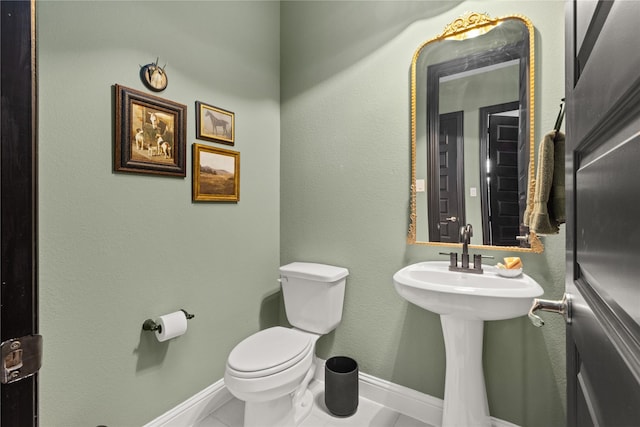 bathroom featuring tile patterned floors and toilet