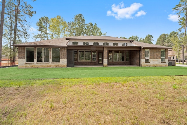 back of property featuring a lawn