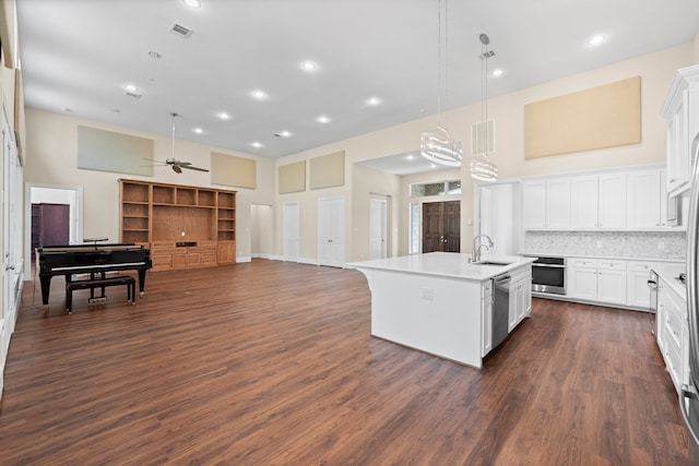 kitchen featuring appliances with stainless steel finishes, hanging light fixtures, white cabinets, ceiling fan, and sink